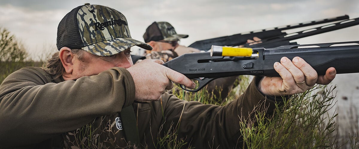 men shooting shotguns